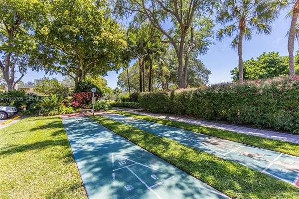 a view of yard with swimming pool and green space