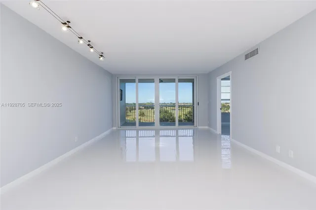 a view of an empty room with a sliding door