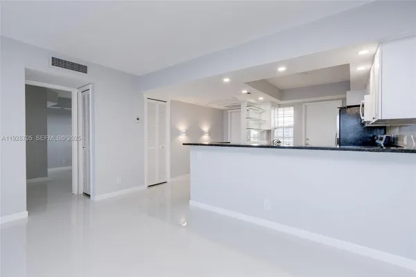 a view of a kitchen with a sink and cabinets
