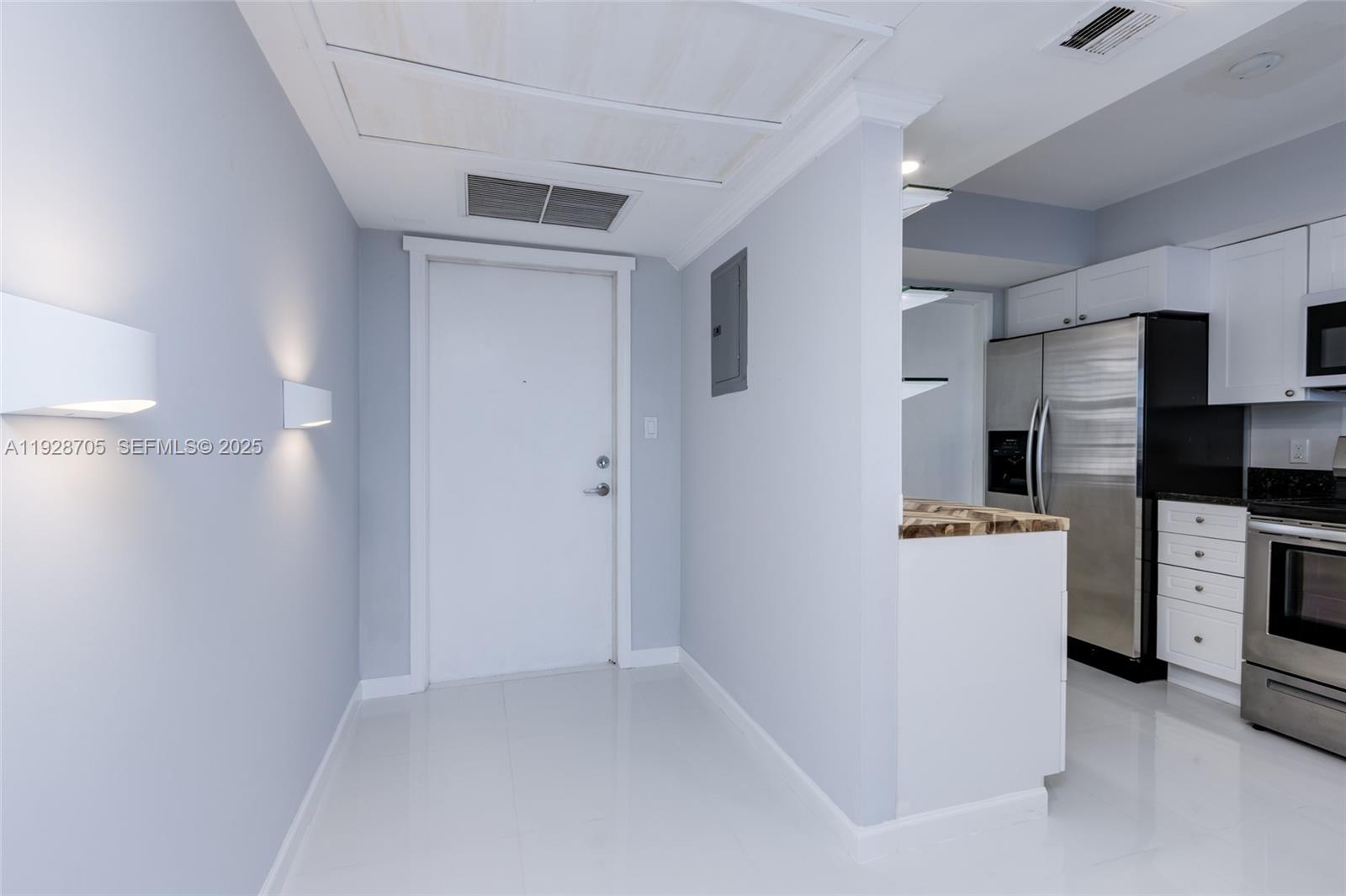 3090 North Course Drive, Unit 609 Pompano Beach, FL 33069 - Photo 10 of 36 a kitchen with a refrigerator and a stove top oven