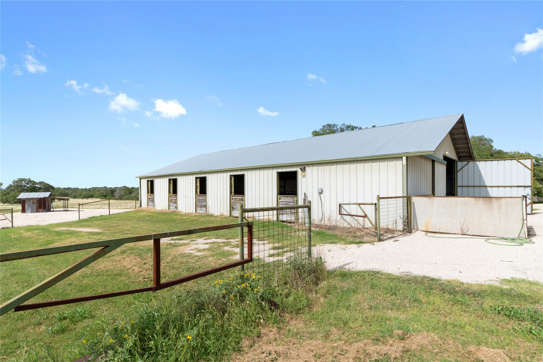 125 Hye Albert Road Hye, TX 78635 - Photo 24 of 39 View of front of house featuring an exterior structure, an outdoor structure, and a metal roof