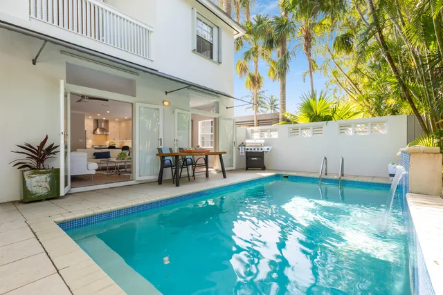 a view of a patio with table and chairs and potted plants