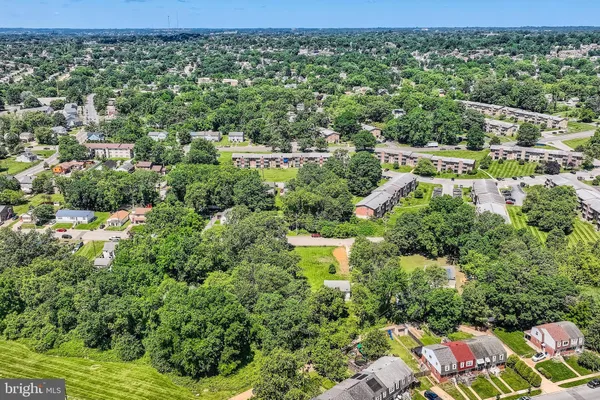 view of a city with lush green forest