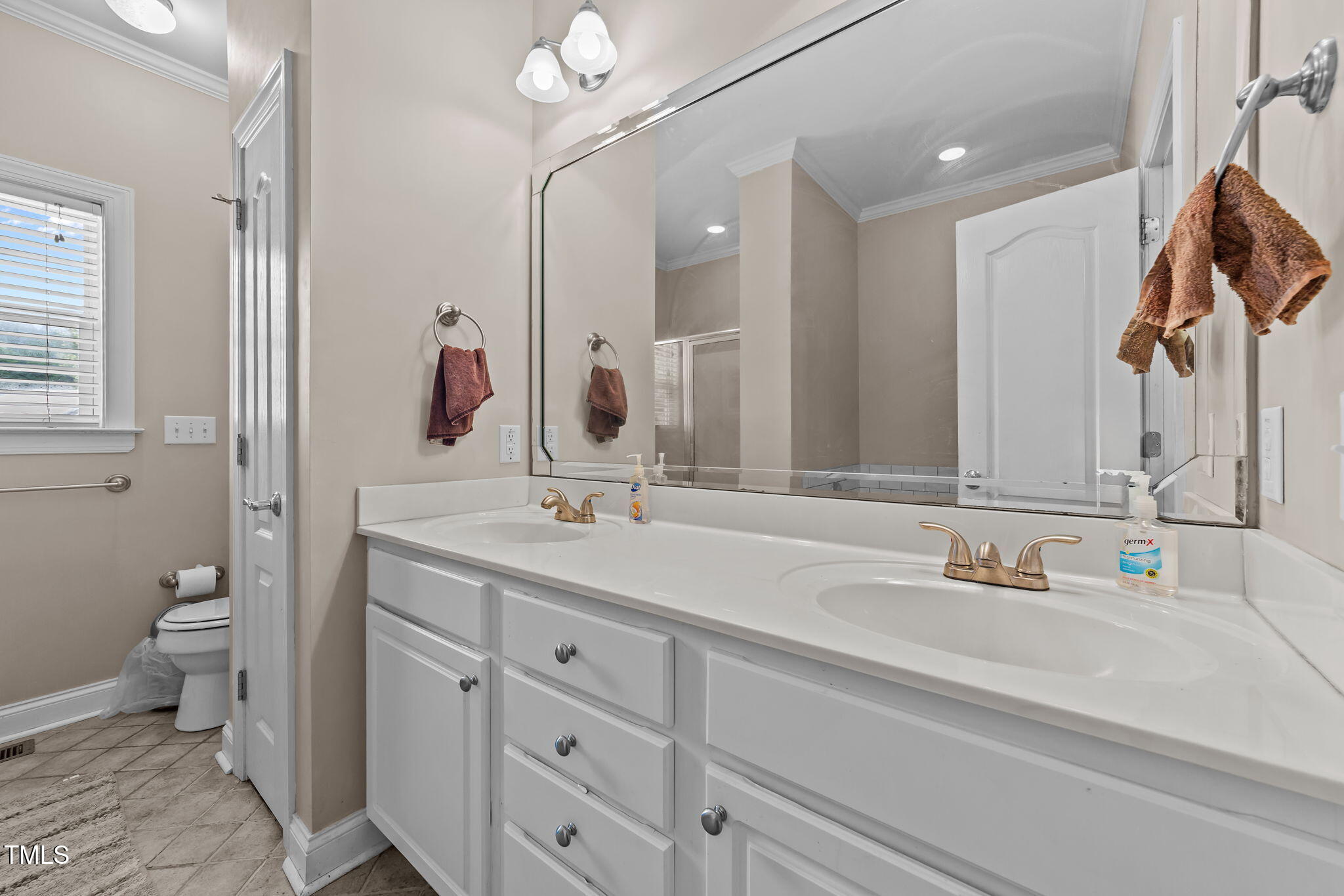 1709 Shell Cracker Drive Willow Spring, NC 27592 - Photo 10 of 28 a bathroom with a sink and a mirror