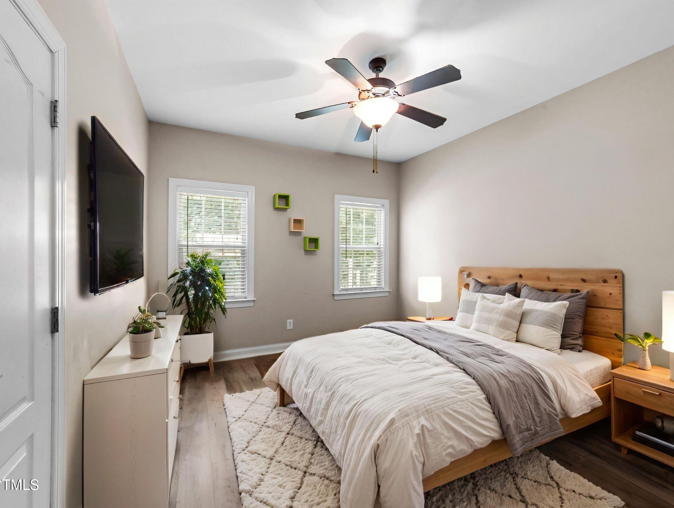 1709 Shell Cracker Drive Willow Spring, NC 27592 - Photo 13 of 28 a bedroom with a large bed and a flat screen tv