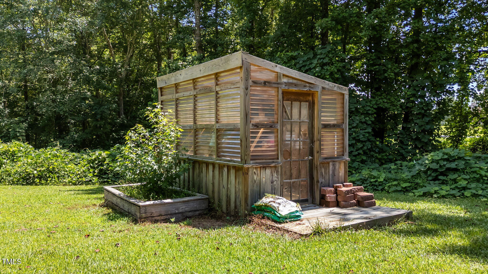 1709 Shell Cracker Drive Willow Spring, NC 27592 - Photo 20 of 28 a backyard of a house with lots of green space and fountain