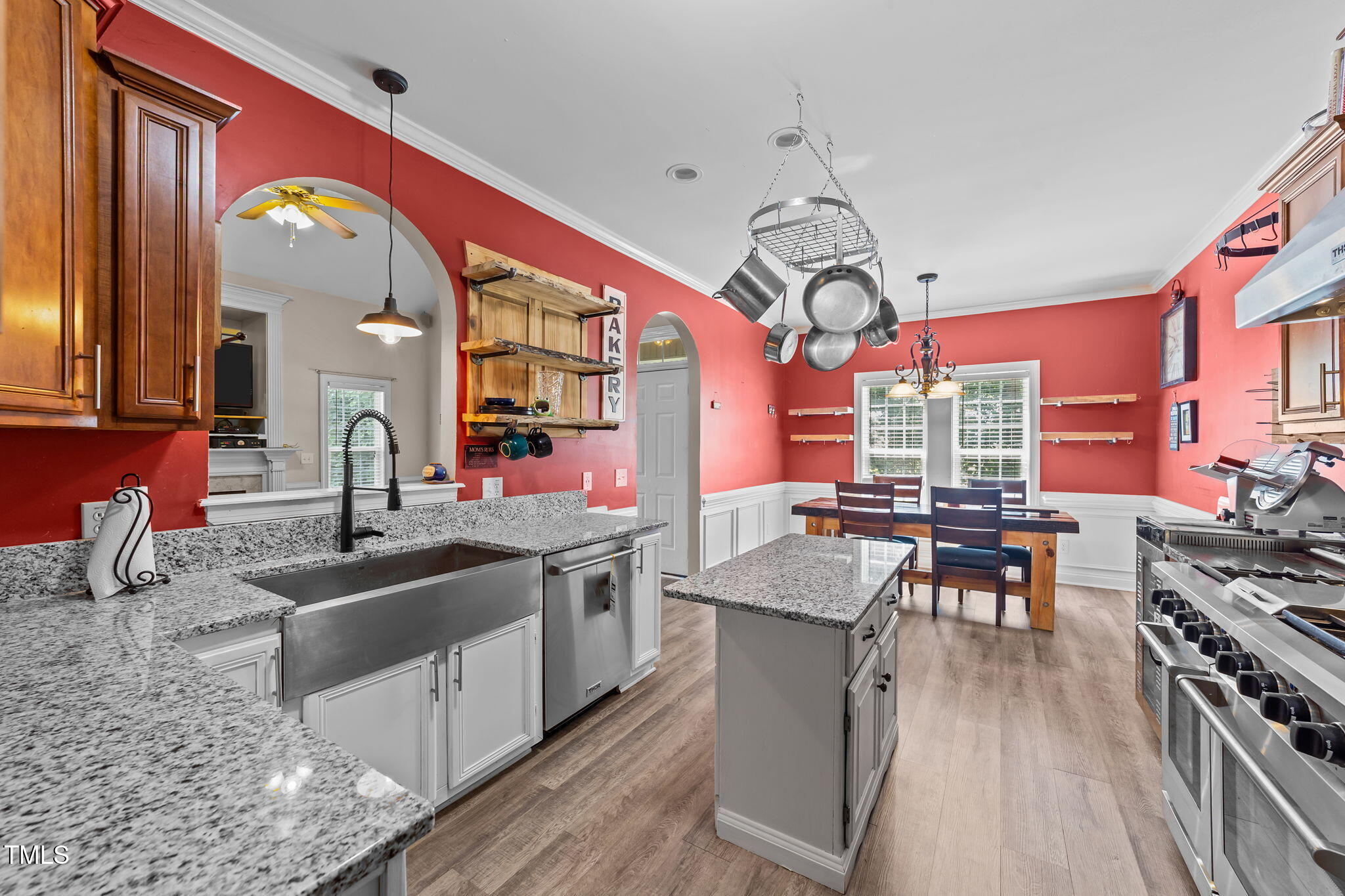 1709 Shell Cracker Drive Willow Spring, NC 27592 - Photo 2 of 28 a kitchen with stainless steel appliances granite countertop a stove a sink dishwasher a dining table and chairs with wooden floor