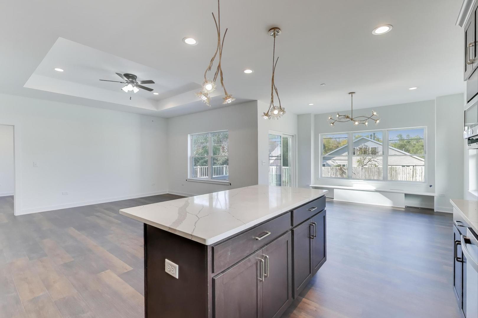 898 North Quentin Road Palatine, IL 60067 - Photo 11 of 28 a kitchen with kitchen island a wooden floor and window
