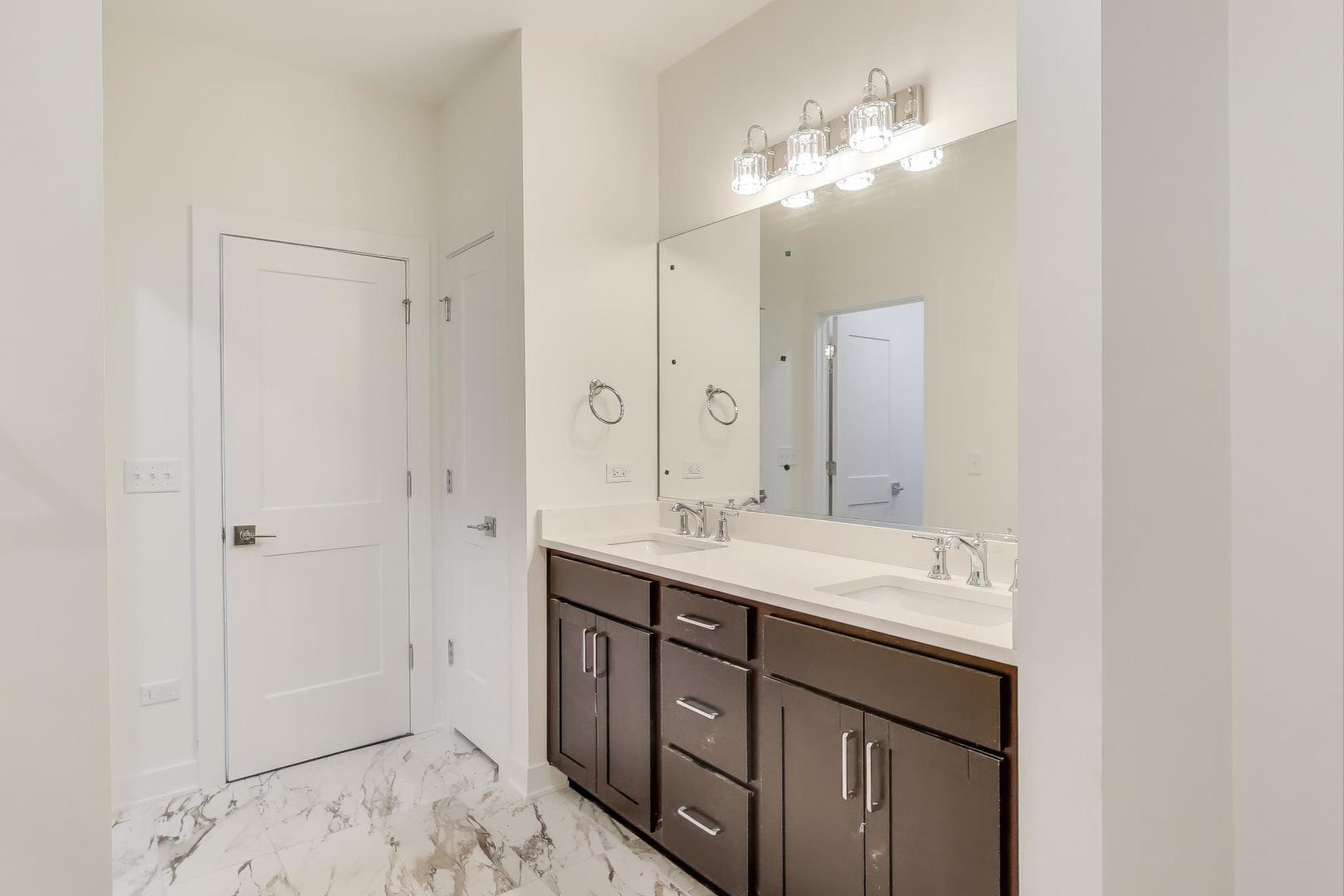 898 North Quentin Road Palatine, IL 60067 - Photo 14 of 28 a bathroom with a double vanity sink and a mirror