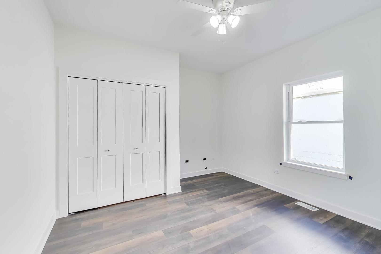 898 North Quentin Road Palatine, IL 60067 - Photo 17 of 28 an empty room with wooden floor and windows