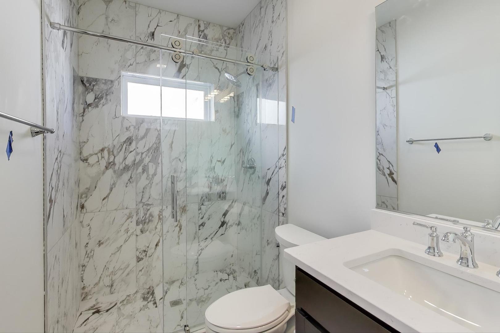 898 North Quentin Road Palatine, IL 60067 - Photo 22 of 28 a bathroom with a sink toilet and shower