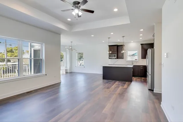 a view of a kitchen with a sink dishwasher and a fireplace