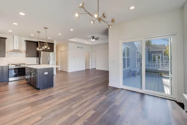 an open kitchen with wooden floor and window