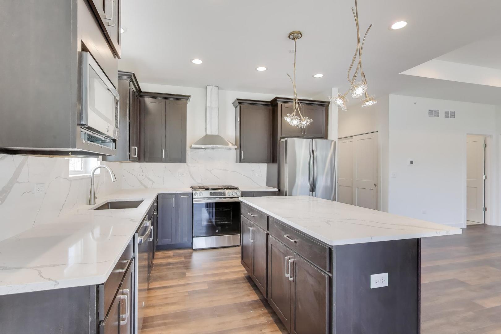 898 North Quentin Road Palatine, IL 60067 - Photo 10 of 28 a open kitchen with stainless steel appliances granite countertop a sink stove and refrigerator