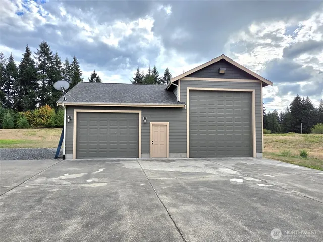 a view of a backyard with large trees
