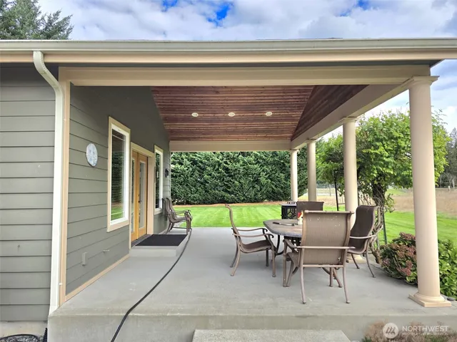 a view of a field with large trees