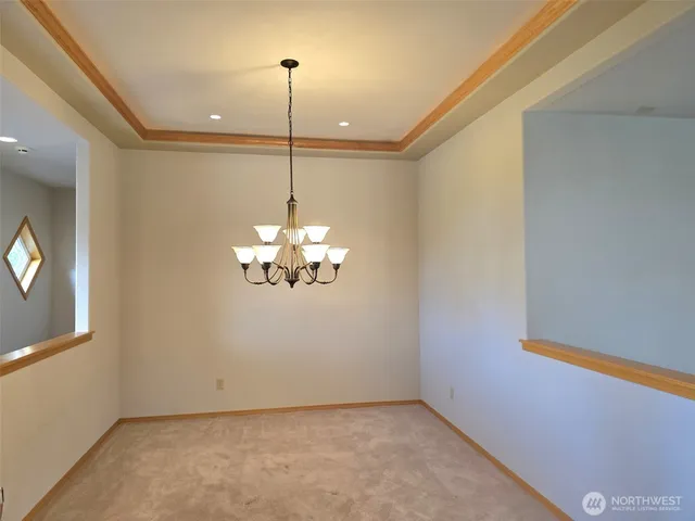 a view of a bath tub sitting in a bathroom next to a window