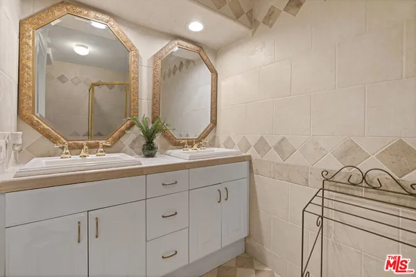 a bathroom with a double vanity sink and mirror