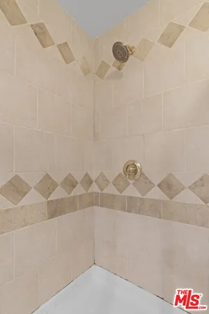 a bathroom with a shower and a shower