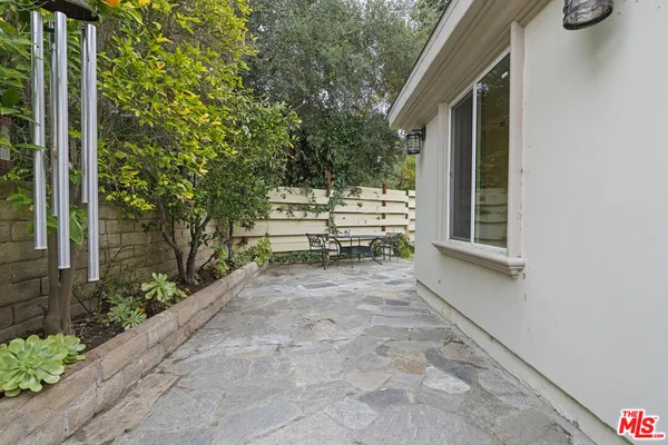 a view of house with backyard and sitting area