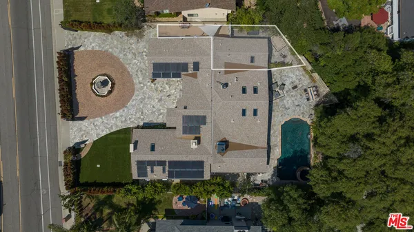 an aerial view of a house with a yard and potted plants