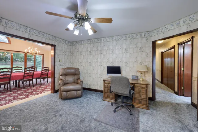 a workspace with furniture and a chandelier