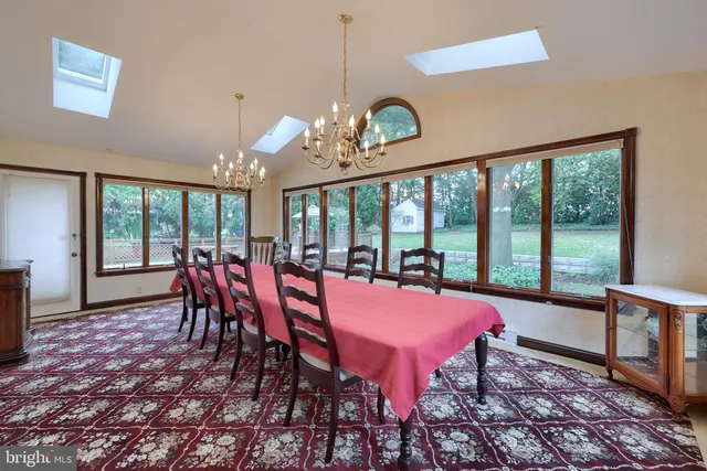 a view of a dining room with furniture large windows and wooden floor
