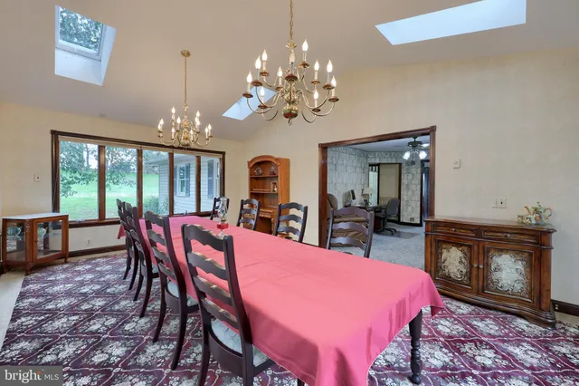 a view of a dining room with furniture and chandelier