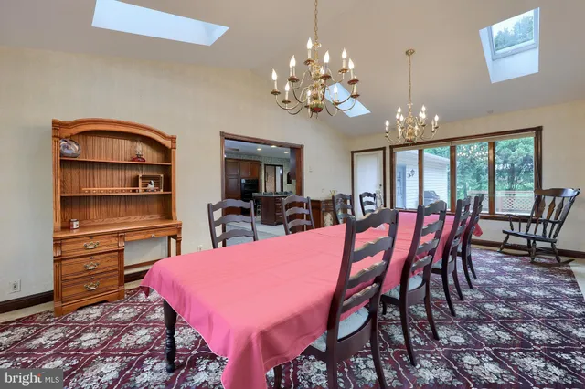 a view of a dining room with furniture and chandelier