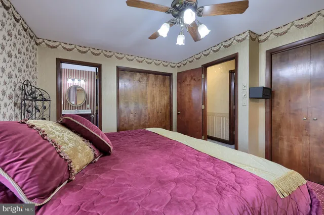 a bedroom with a large bed and a chandelier