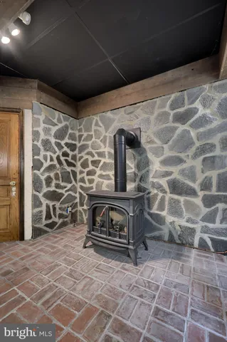 a room with furniture and stainless steel appliances