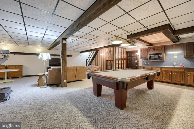 a kitchen with stainless steel appliances granite countertop a sink a stove and cabinets