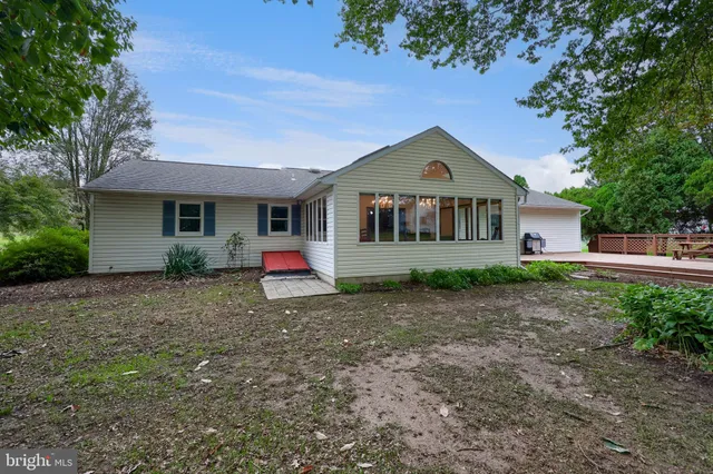 a view of a house with backyard sitting area and garden