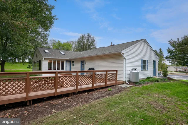 a house with huge green field in front of it