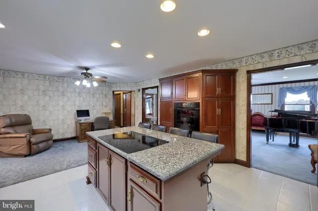 a kitchen that has a lot of cabinets a sink and a refrigerator
