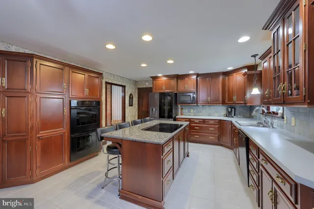 a kitchen with stainless steel appliances granite countertop refrigerator sink and stove