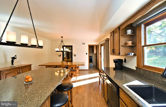 a kitchen with stainless steel appliances granite countertop sink stove and refrigerator