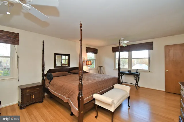 a bedroom with furniture and a wooden floor