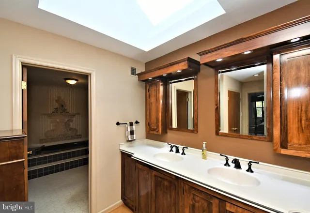 a bathroom with a double vanity sink and mirror