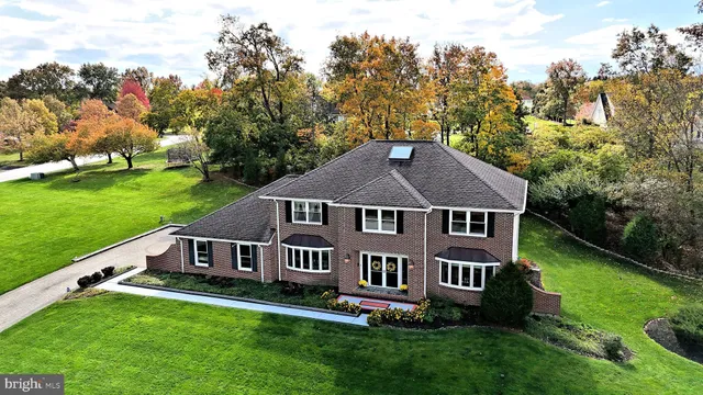 a aerial view of a house with a yard table and chairs