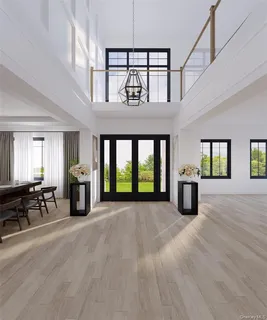 a view of an empty room with furniture fireplace and windows