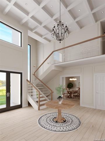 a view of entryway and hall with a dining table