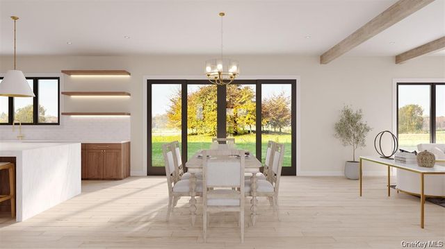 a view of a dining room with furniture a chandelier and wooden floor