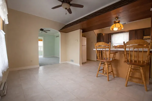 a view of a livingroom with a ceiling fan and window