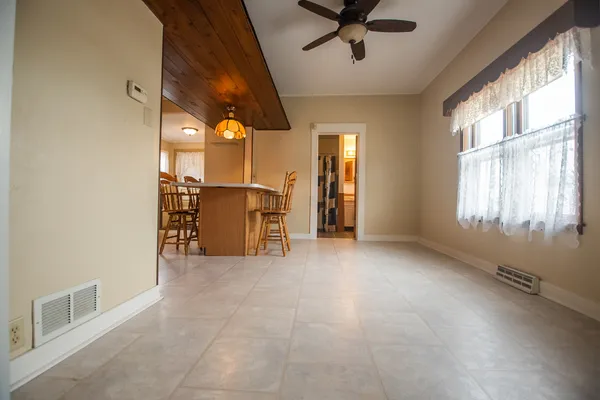 a view of a livingroom with a ceiling fan and window