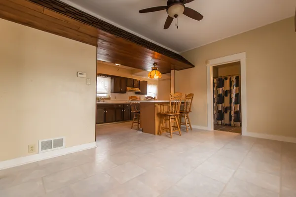a view of a dining room with furniture and a chandelier