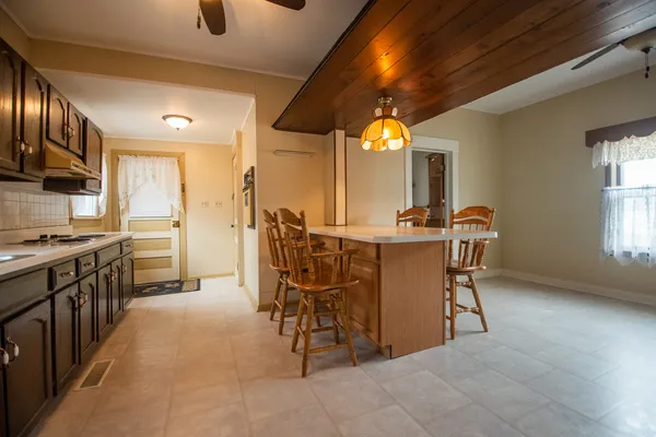 a view of a dining room with furniture and chandelier