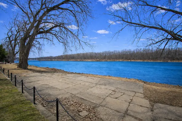 a view of a yard with wooden fence