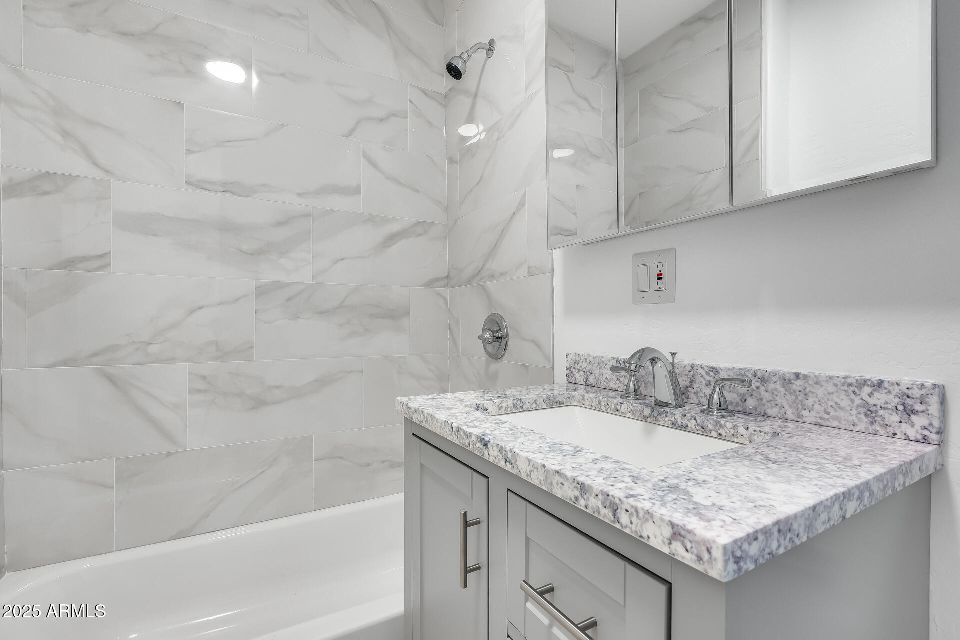 3138 West Ravina Lane Anthem, AZ 85086 - Photo 11 of 38 a bathroom with a granite countertop sink a toilet and bathtub