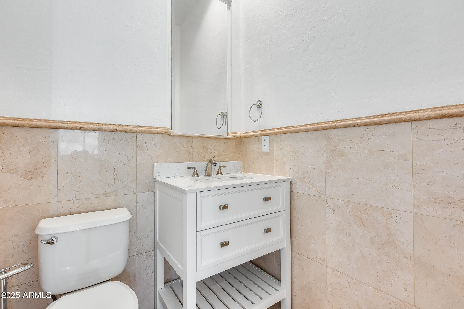 3138 West Ravina Lane Anthem, AZ 85086 - Photo 12 of 38 a bathroom with a sink a toilet and vanity